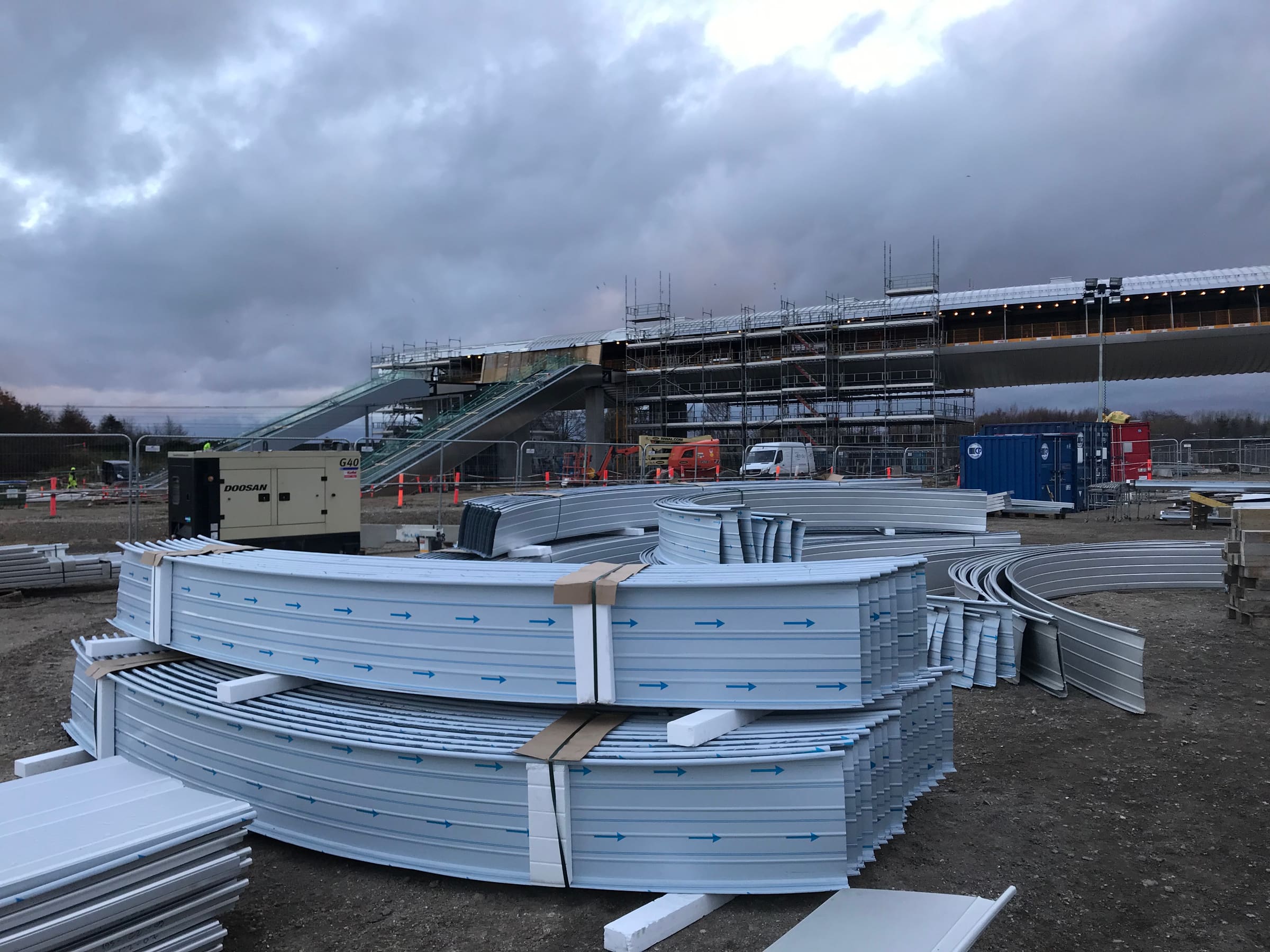 Køge Nord Station footbridge, curved aluminum cladding panels staged on site